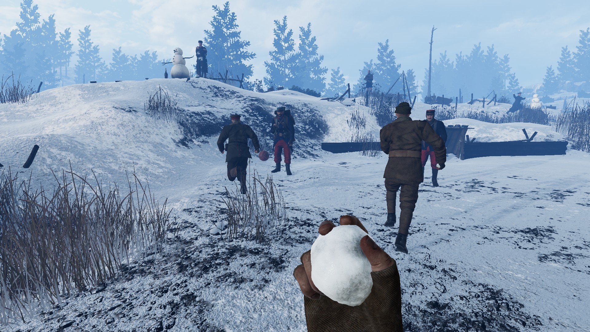 Soldiers run after a football while the player is holding a snowball.
